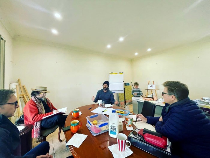 The artists talking with Brendan Booth of Booth Agriculture