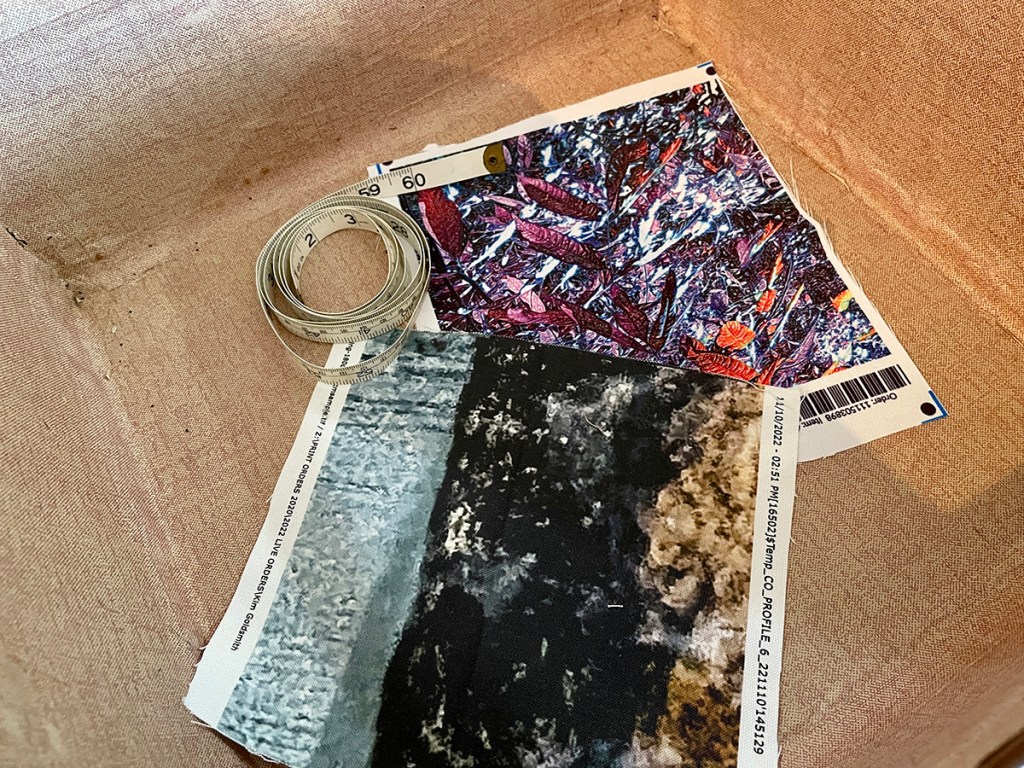 The second of two images, this shows two custom-designed fabric samples inside a vintage suitcase with a coiled tape measure.